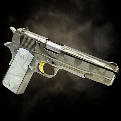 Custom Rock Island 1911 .38 Super pistol with a black and white chrome camouflage design, 24K gold trigger, and white grips.