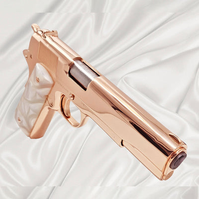 Custom Rock Island 1911 .45 ACP pistol with 18K rose gold plating and a high mirror finish, on white satin.