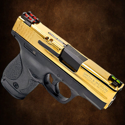 Custom Smith & Wesson M&P Shield 9mm handgun with a full 24K gold plated finish, side view.